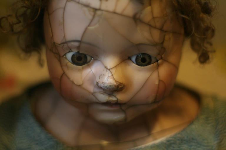 Porcelanowa laleczka z popękaną twarzą